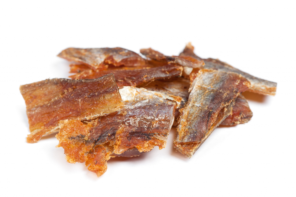 Dried pollack fish jerky on a whilte background. Homemade jerky at its finest.